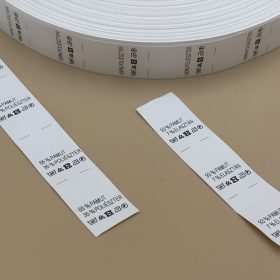   Bérnyomtatás  - TEXTIL bevarrható műanyag címkére - POLYESTER - MOSÁS TÁJÉKOZTATÓ